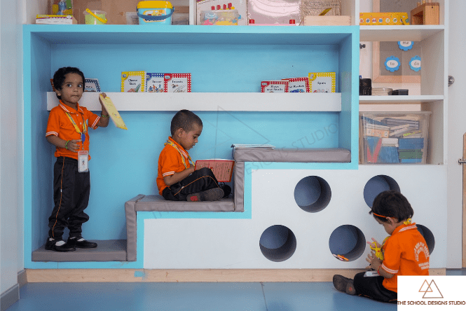 Activity zone for preschoolers at Little Kids Playhouse & Preschool, Tiruvallur designed by The School Designs Studio, featuring built-in reading steps, child-friendly shelves, and interactive play elements that enhance exploration and student engagement.